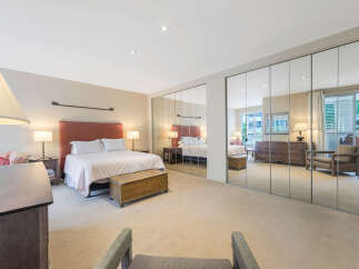 This stunning bedroom boasts a spacious layout with ample natural light, creating a serene and inviting atmosphere.