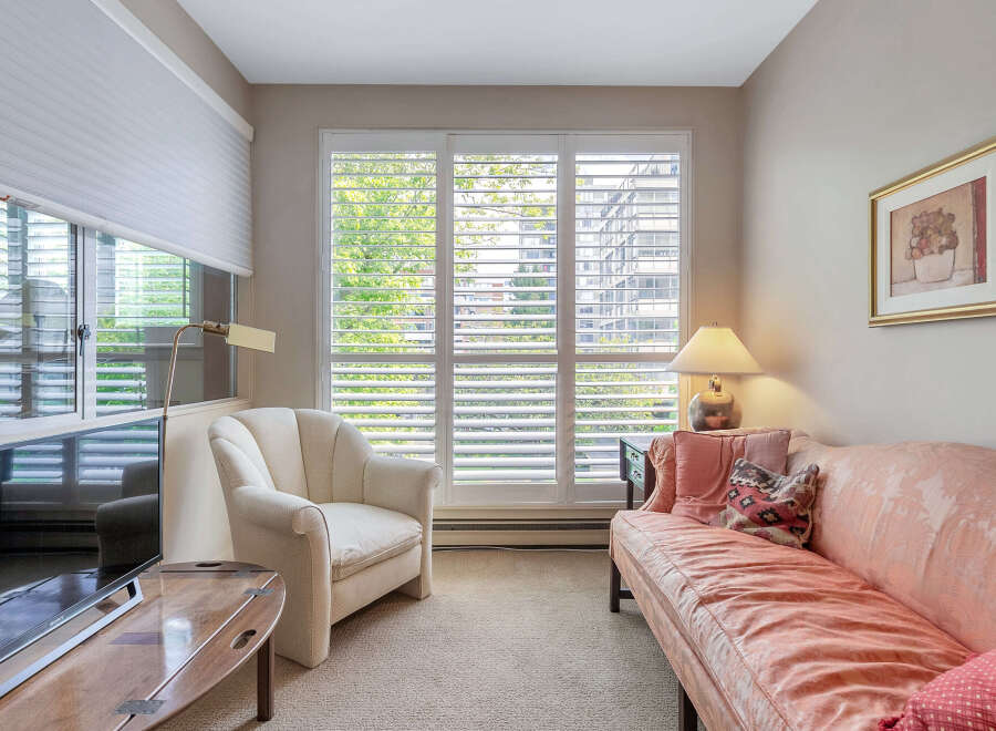 This cozy living room features a comfortable sofa and a stylish armchair, perfect for relaxing.