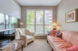 This cozy living room features a comfortable sofa and a stylish armchair, perfect for relaxing.