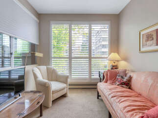 This cozy living room features a comfortable sofa and a stylish armchair, perfect for relaxing.