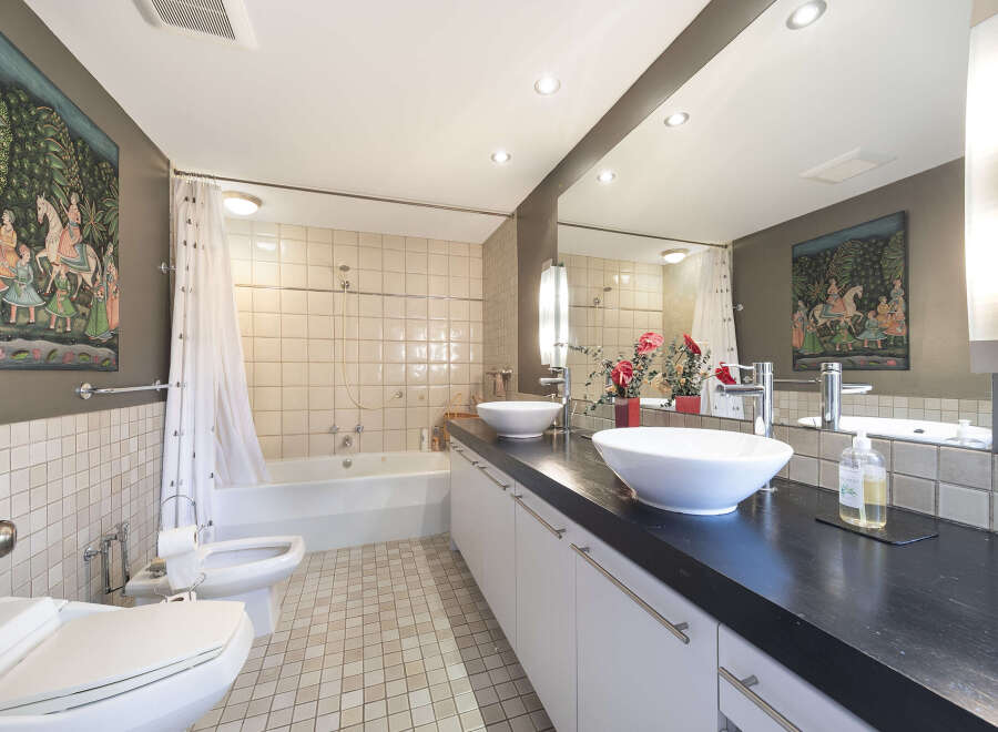 Step into this luxurious bathroom, featuring a sleek, modern design.