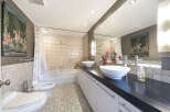 Step into this luxurious bathroom, featuring a sleek, modern design.