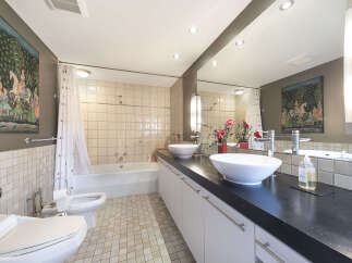 Step into this luxurious bathroom, featuring a sleek, modern design.