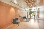Step into luxury with this stunning entryway, featuring sleek wooden paneling and modern track lighting.