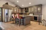 This stunning kitchen boasts a modern design with high-end appliances and custom cabinetry.