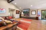 Step into luxury with this stunning living room, featuring a cozy fireplace and a large TV perfect for entertainment.