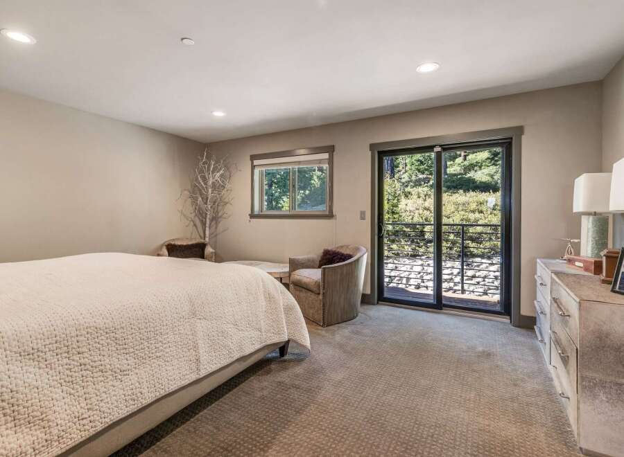 Step into this serene bedroom, featuring a cozy bed and inviting seating areas.