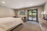Step into this serene bedroom, featuring a cozy bed and inviting seating areas.