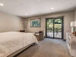 Step into this serene bedroom, featuring a cozy bed and inviting seating areas.
