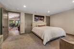 Step into this inviting bedroom, featuring a cozy bed and a stunning landscape artwork.