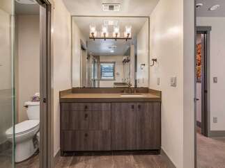 Step into luxury with this stunning bathroom! Featuring a modern vanity with ample storage, a sleek countertop, and a large mirror, this space is designed for both style and functionality.