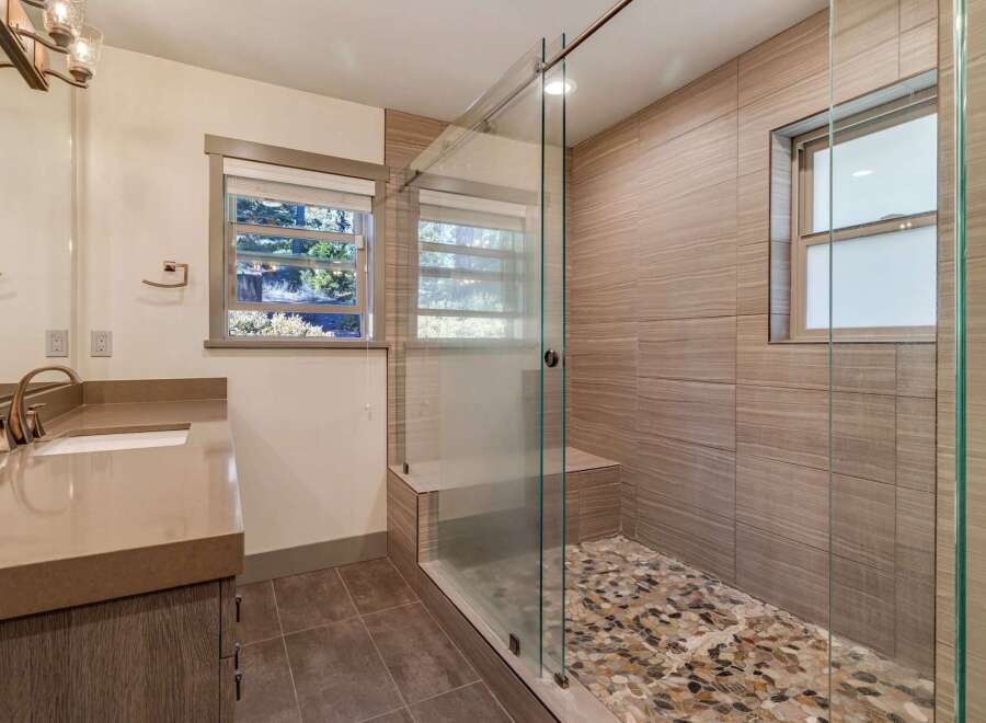 Step into luxury with this stunning bathroom featuring a modern glass shower enclosure.