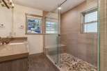 Step into luxury with this stunning bathroom featuring a modern glass shower enclosure.