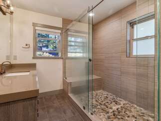 Step into luxury with this stunning bathroom featuring a modern glass shower enclosure.