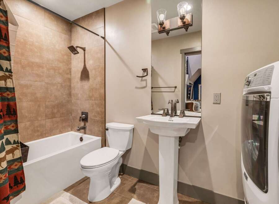 This charming bathroom features a combination of rustic and modern elements, creating a warm and inviting space.