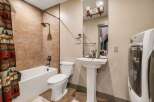 This charming bathroom features a combination of rustic and modern elements, creating a warm and inviting space.