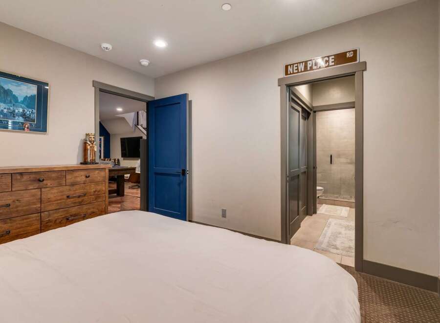 Discover the charm of this inviting bedroom, featuring a comfortable bed and a stylish wooden dresser.