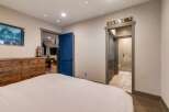 Discover the charm of this inviting bedroom, featuring a comfortable bed and a stylish wooden dresser.