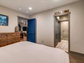 Discover the charm of this inviting bedroom, featuring a comfortable bed and a stylish wooden dresser.