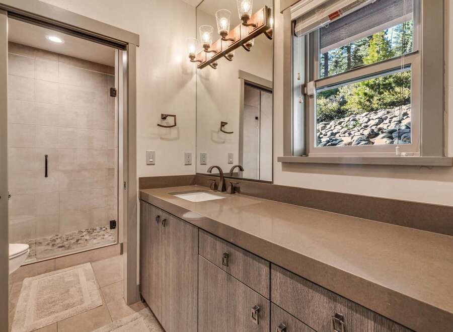 This stunning bathroom boasts a modern design with a sleek vanity and a spacious walk-in shower.