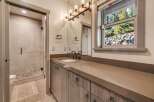 This stunning bathroom boasts a modern design with a sleek vanity and a spacious walk-in shower.