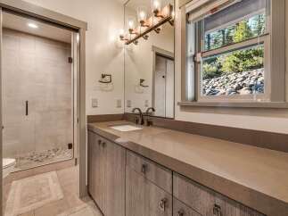 This stunning bathroom boasts a modern design with a sleek vanity and a spacious walk-in shower.