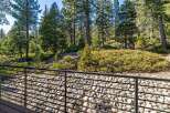 Enjoy the tranquility of nature from this stunning property! This home features a beautiful view of the surrounding forest, with a modern deck and a rock garden.