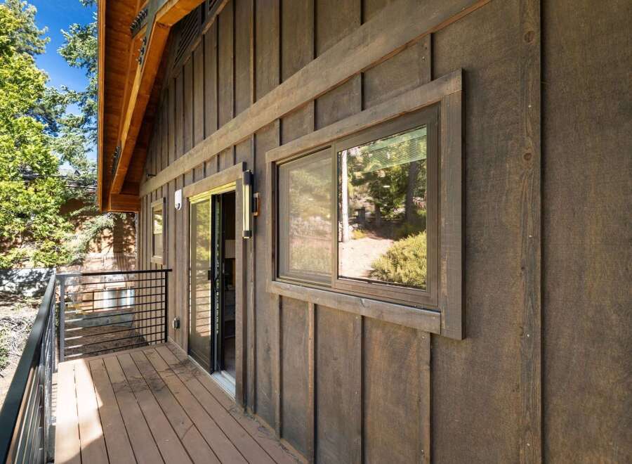 Discover the charm of this stunning property, featuring a beautifully designed exterior with rich wooden siding.