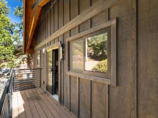 Discover the charm of this stunning property, featuring a beautifully designed exterior with rich wooden siding.