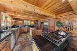 Step into this stunning kitchen, boasting a rustic charm with its wooden accents and stone flooring.