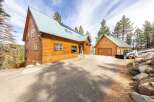 This stunning property boasts a beautiful wooden exterior and a charming design, perfect for those seeking a mountain retreat.