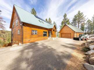 This stunning property boasts a beautiful wooden exterior and a charming design, perfect for those seeking a mountain retreat.