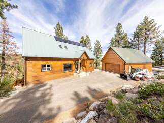 Discover your dream retreat in this stunning property! This home boasts a modern design with a unique roofline and solar panels, offering both style and sustainability.