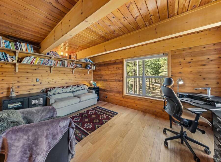 Step into this cozy cabin retreat, featuring a warm wooden interior and a bright, inviting atmosphere.