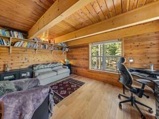 Step into this cozy cabin retreat, featuring a warm wooden interior and a bright, inviting atmosphere.