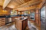 Step into this stunning kitchen, featuring a rustic design with wooden walls and ceiling, creating a warm and inviting atmosphere.