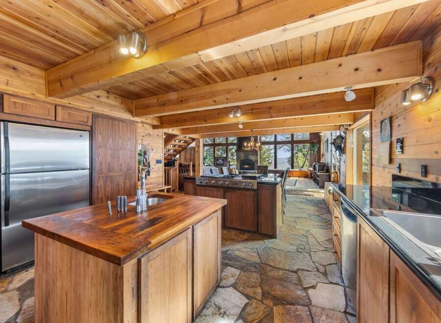 Step into luxury with this stunning kitchen, featuring a rustic wooden design and modern appliances.