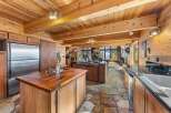 Step into luxury with this stunning kitchen, featuring a rustic wooden design and modern appliances.
