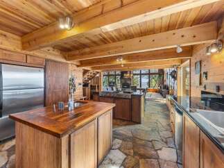 Step into luxury with this stunning kitchen, featuring a rustic wooden design and modern appliances.