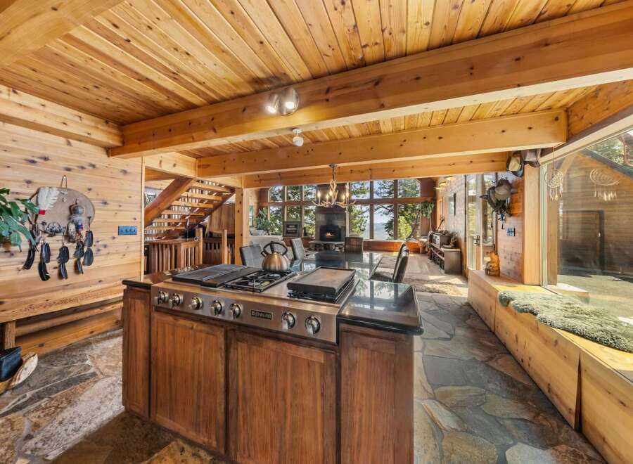 Experience luxury living in this stunning home with a gourmet kitchen featuring a Jenn-Air cooktop and a spacious island.