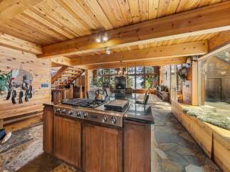 Experience luxury living in this stunning home with a gourmet kitchen featuring a Jenn-Air cooktop and a spacious island.