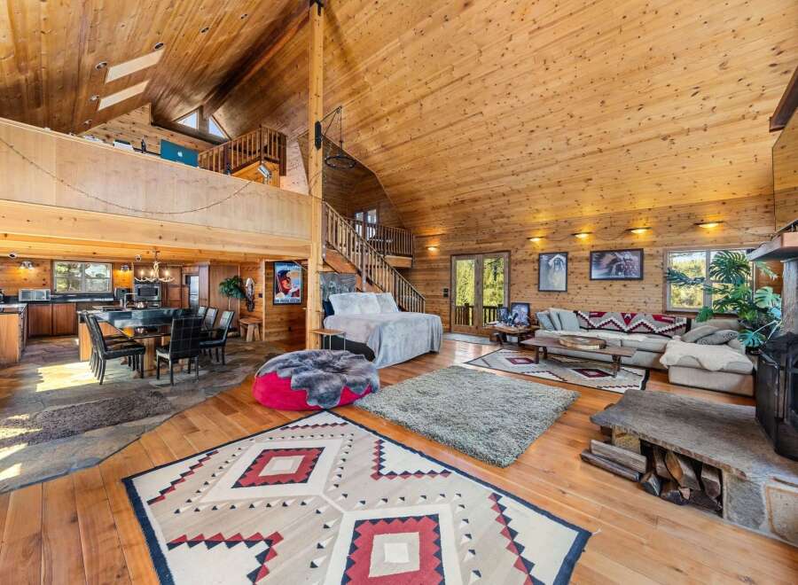 Step into luxury with this stunning log cabin home, boasting a spacious open floor plan and soaring ceilings.