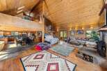 Step into luxury with this stunning log cabin home, boasting a spacious open floor plan and soaring ceilings.