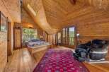 Step into this stunning bedroom retreat, featuring exquisite wood paneling and a vaulted ceiling that exudes warmth and character.