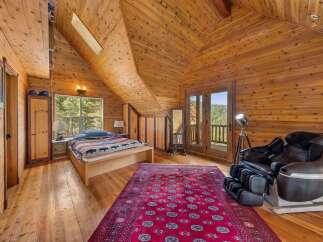 Step into this stunning bedroom retreat, featuring exquisite wood paneling and a vaulted ceiling that exudes warmth and character.