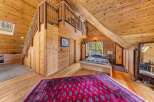 Step into rustic charm with this stunning bedroom featuring a unique loft space and warm wooden accents.