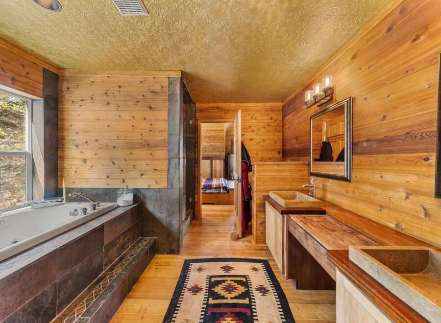 Step into a luxurious bathroom retreat with natural wood accents and a spa-like ambiance.