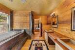 Step into a luxurious bathroom retreat with natural wood accents and a spa-like ambiance.