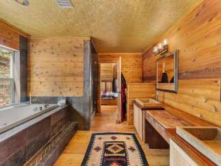 Step into a luxurious bathroom retreat with natural wood accents and a spa-like ambiance.