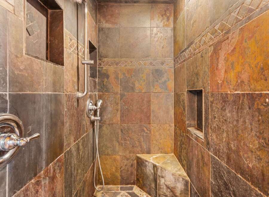 Step into luxury with this stunning shower featuring exquisite tile work and a sleek, modern design.
